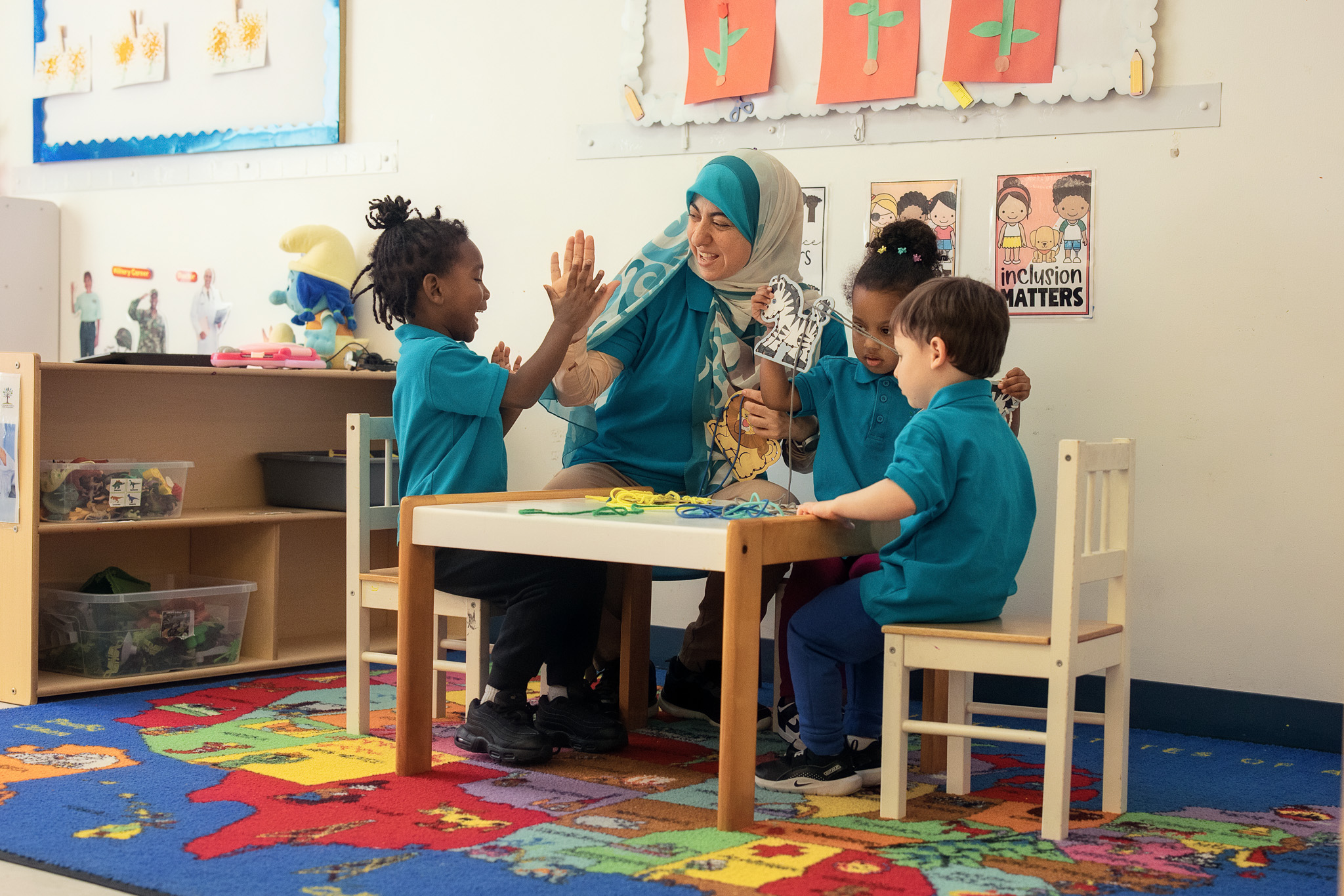 Teacher high-fiving a student at Little Newtons Academy