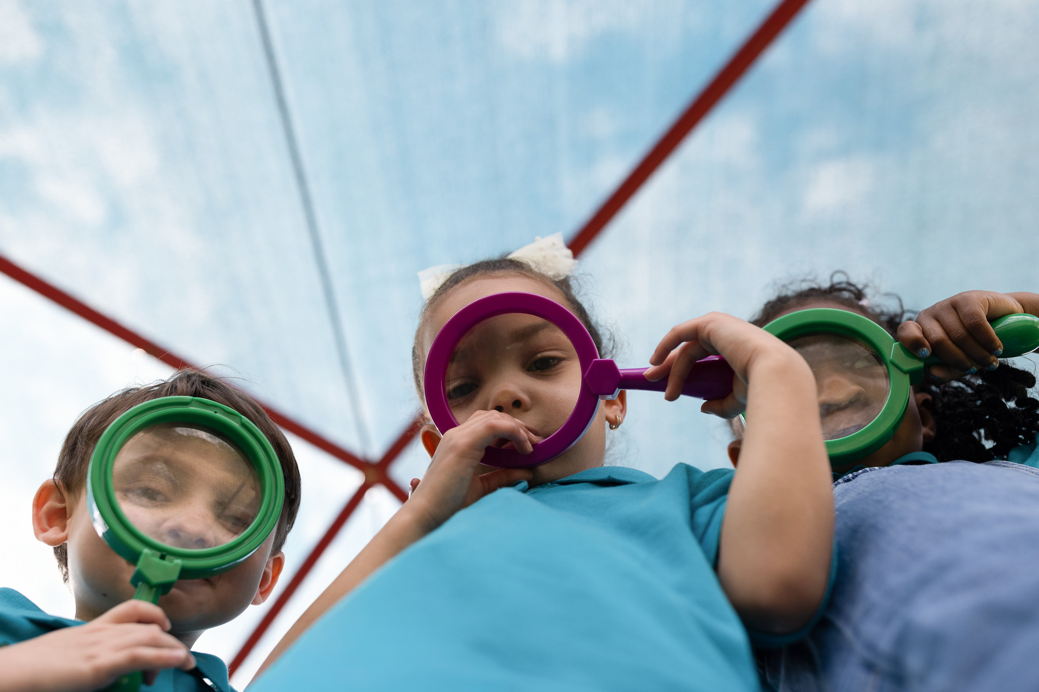 Children playing and dancing outdoors at Little Newtons Academy