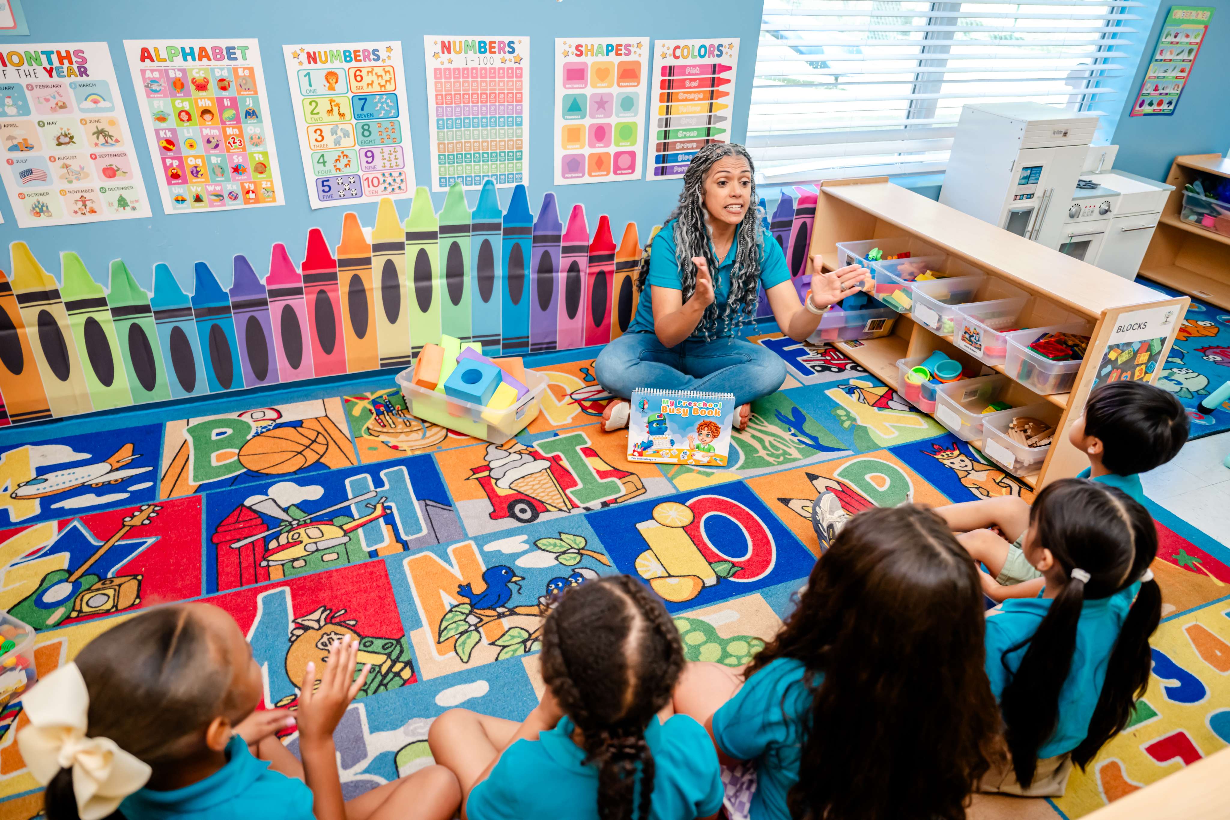 Teacher leading circle time with children on the classroom rug