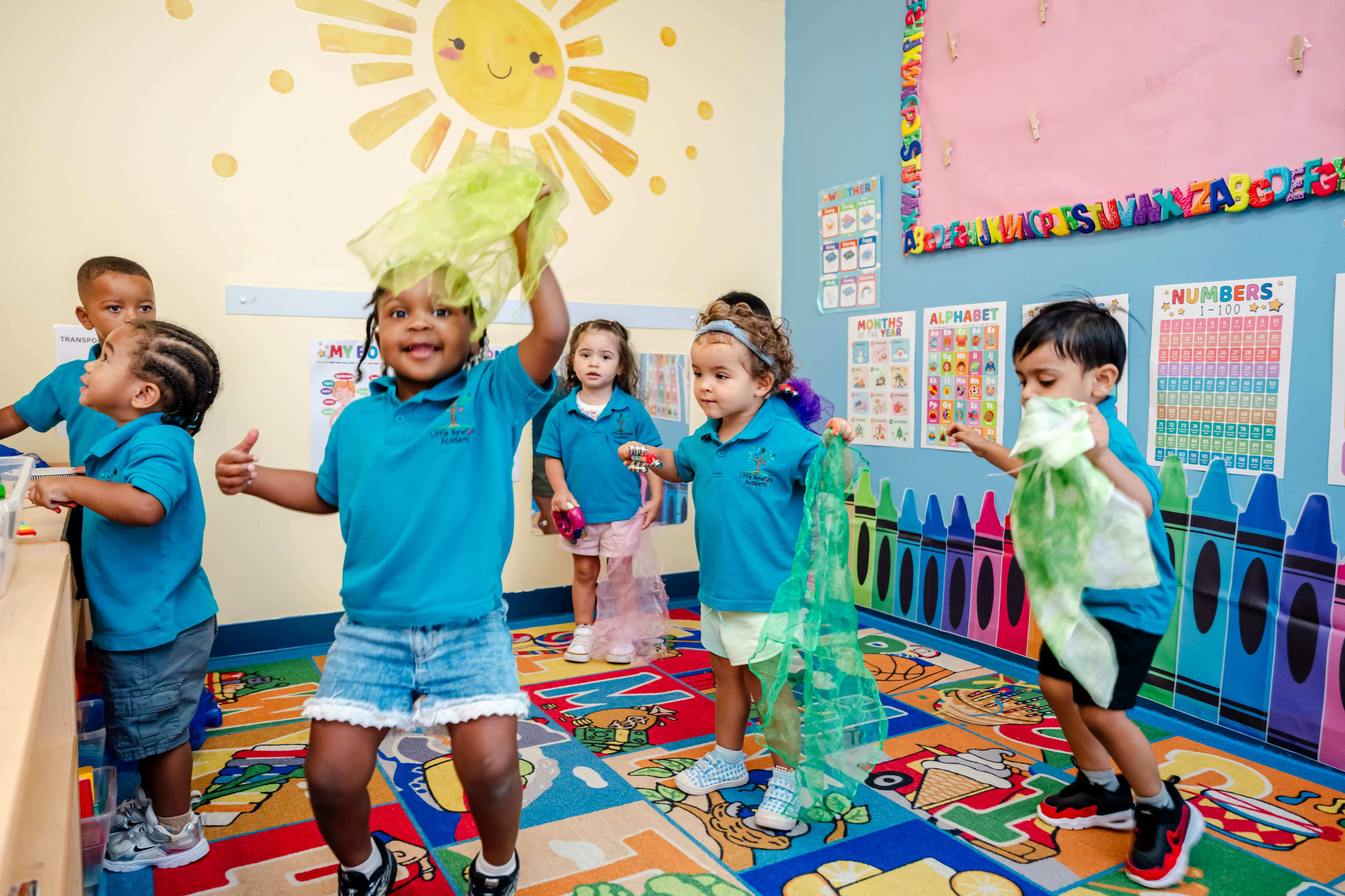 Children dancing with colorful scarves during a music and movement activity